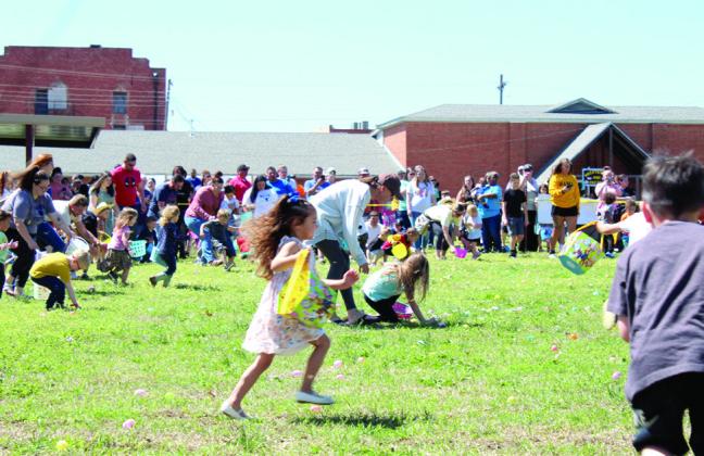Three-and-four-year-olds dash out onto the field of plastic eggs during the Tecumseh EGGsperience and Block Party.