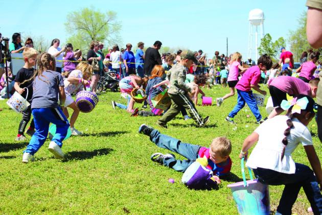 One boy in the five-to-six-year age group takes a tumble as he races onto the field of plastic eggs.