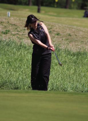 Tecumseh senior Angelic Duggan chips the ball up a hill to the 10th hole during the Tecumseh Girls Golf Tournament on April 16.