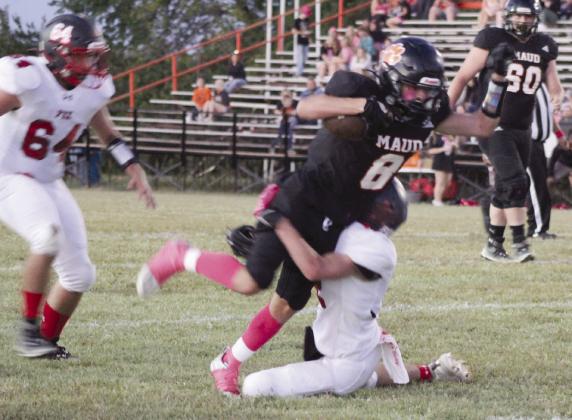 Pictured right, Maud junior Trustin Smith is tripped up by a Fox defender in the Pink Out Homecoming game on Oct. 5. The Maud Tigers won, 50-0. Countywide &amp;amp; Sun/Natasha Dunagan