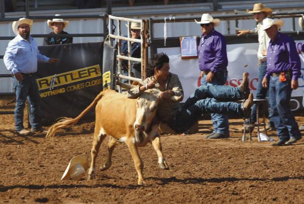 Blake Huddleston of McLoud descends on his steer and tries to wrestle him to the ground in the second go-round of the IFYR on the morning of July 11. Natasha Dunagan, Countywide &amp; Sun