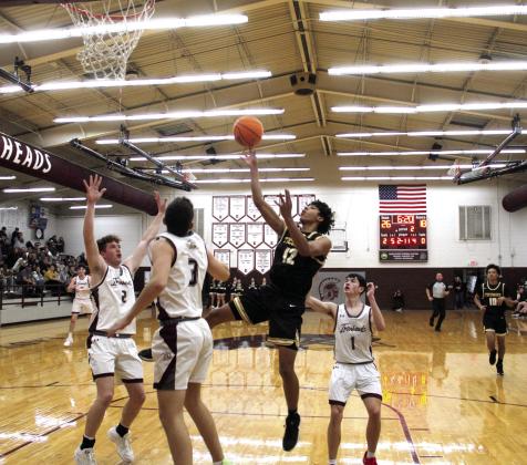 Tecumseh's Sherman Mitchell aims at the bucket during the second quarter of the Class 4A Districts at Eufaula on Feb. 21. The Savages made a three-point shot in the last two seconds to win, 69-67. Photo courtesy of Rodney Haltom/Eufaula Indian Journal