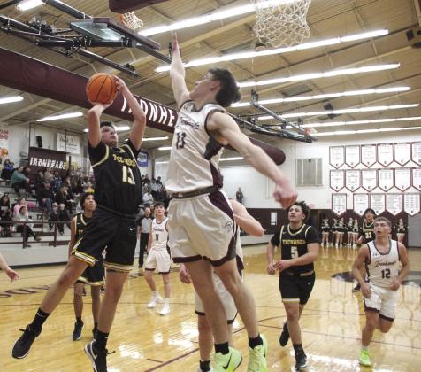 Tecumseh's Creed Wright shoots over the Ironhead's defense during the Class 4A Districts at Eufaula on Feb. 21. The Savages made a three-point shot in the last two seconds to win, 69-67. Photo courtesy of Rodney Haltom/ Eufaula Indian Journal
