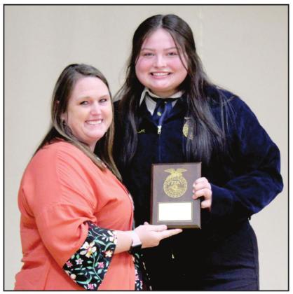 Tecumseh 4-H and FFA Booster Club representative Jenny Countess presents the Matt Brown Memorial Award to Whitlee Davis.