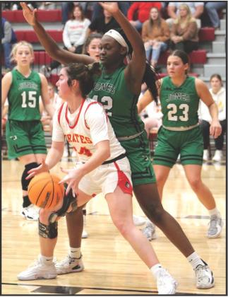 Karsen Griggs is surrounded as she looks to pass to Makenzy Herman, who hit her shot.
