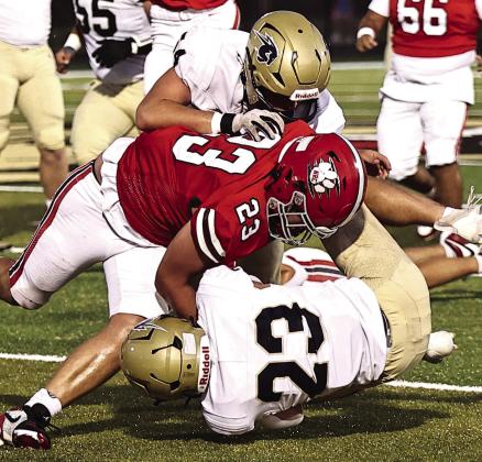 NRC's Brodie Grace makes the hit on the Heritage Hall player Sept. 26. Photo courtesy of Gowin Photography