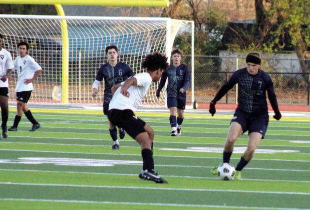Shawnee’s Camden Sateren maneuvers around a Victory Christian defender during the April 2 home game.