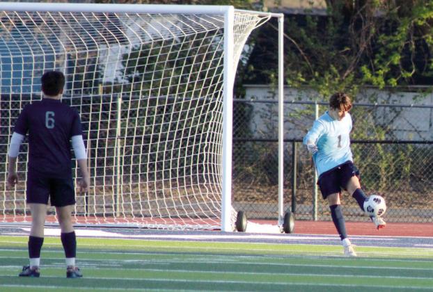 Shawnee goalie Hayden Spears kicks the ball back into play during the April 2 game with Victory Christian.