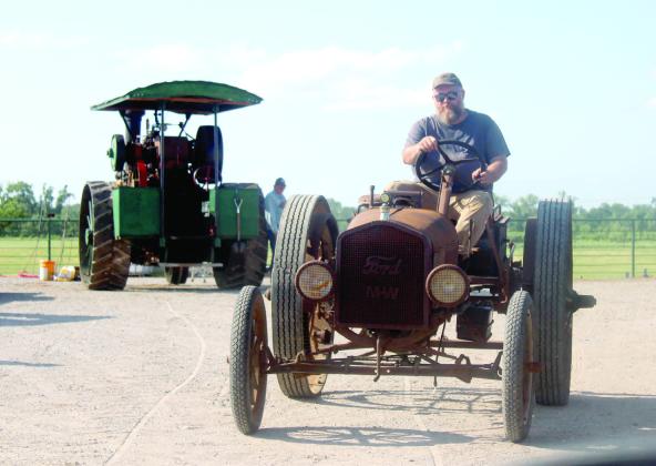 Shawnee Tractor and Engine Club President Shawn Singleton drives a Depression-era Ford Model T Tractor during the 26th Annual Farming Heritage Festival on June 20. Singleton said a kit could be bought for $94 through the Montgomery Ward catalog to convert a Model T into a tractor.