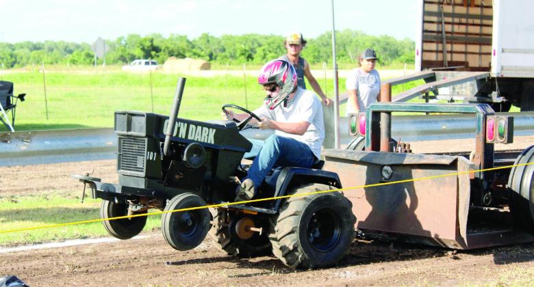 Kendall Williams pulls in the Junior Stock Class of the Garden Tractor Pulls at the 26th Annual Farming Heritage Festival on June 21 at Shawnee Feed Center. Williams distance was 113.86 feet.