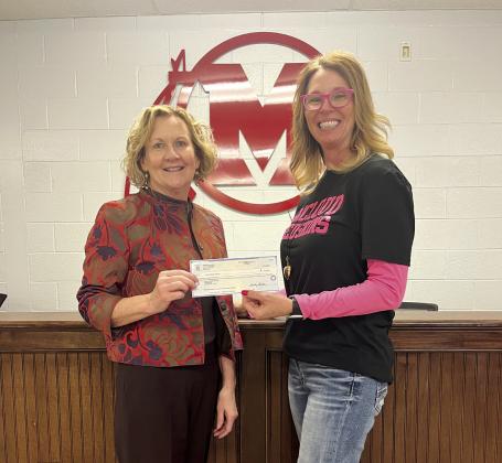 Audrey Seeliger, External Relations-Special Events for fhe Avedis Foundation, presents a check to Rhonda Hockenbury (left), Superintendent McLoud Public Schools. Photo provided