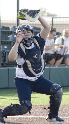 Shawnee senior Adesyn Waite jumps up to catch the ball during the McAlester game in the Shawnee Softball Tournament.