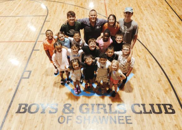 Julio Sanchez, back row and second from left, the director, poses with mentors and club kids at The Salvation Army Boys and Girls Club at Shawnee. Photo provided