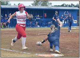 Bethel’s Payton Epperly (pictured left) stretches for the out at first base in the home game against Washington.