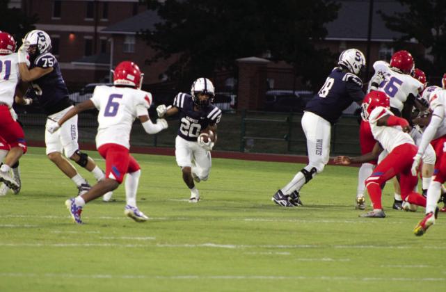 Shawnee junior Deetrick Beavers carries the ball, navigating between two Bears, during the Homecoming game against John Marshall, held at OBU on Oct. 6. The Wolves won, 37-0. Countywide &amp; Sun/Natasha Dunagan