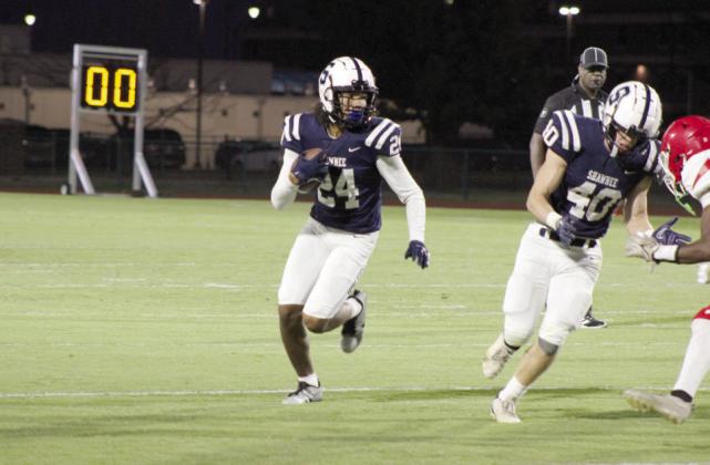 Shawnee junior Dace Shaw runs the ball in the first quarter as senior Jayson Hair defends him during the Homecoming game against John Marshall, held at OBU on Oct. 6. The Wolves won, 37-0. Countywide &amp; Sun/Natasha Dunagan