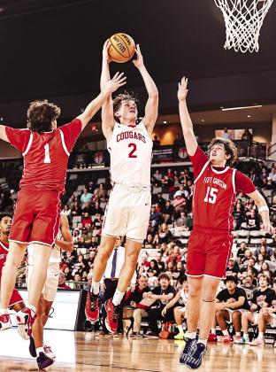Kohen Warden puts up a shot between two Fort Gibson defenders.