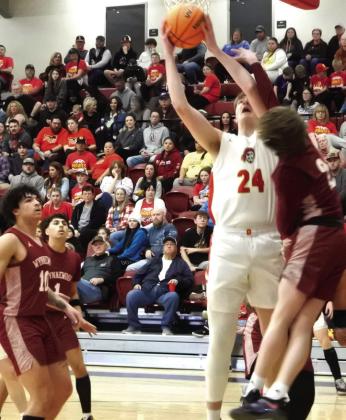 Dale sophomore Trayden Chambers tries to make his shot around a Wynnewood defender.