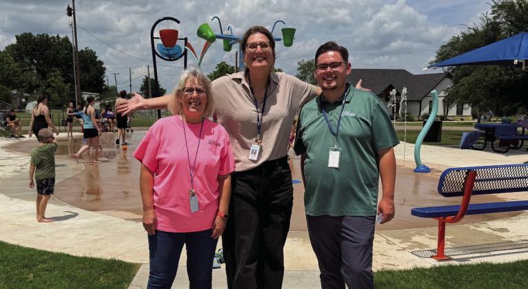 Shawnee Parks and Recreation staff members Jane Wright, Kerri Foster, and Cord Bender celebrate the opening of Optimist Park Splash Pad. Photo Provided