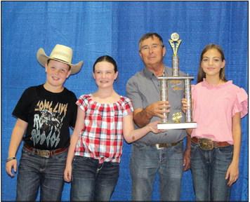 Members of Dale 4-H accept the 4-H and FFA Beef Herdsman Award on Sept. 9 from Pottawatomie County Free Fair Board Member Lynn Marlow. They are, from left, Bryar Baker, Taycie Baker and Katie Haysmer. Countywide &amp; Sun/Natasha Dunagan