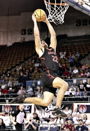 North Rock Creek's Caleb Hawkins goes up for the dunk. NRC won the first round of the State games, beting Bethany 61-56. The Cougars lost to Weatherford, 58-68, Friday, Mar. 14 in the semi-finals. Weatherford went on to claim the State Championship title. Photo courtesy of Gowin Photography