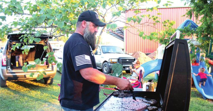 Wanette Mayor Nathan Gregory grills burgers during the Wanette Independence Day event on July 4. Burgers, hot dogs, and nachos were being sold to raise money for the Flag Day event, which is held on the second Saturday of June each year. Countywide &amp;amp; Sun/Natasha Dunagan