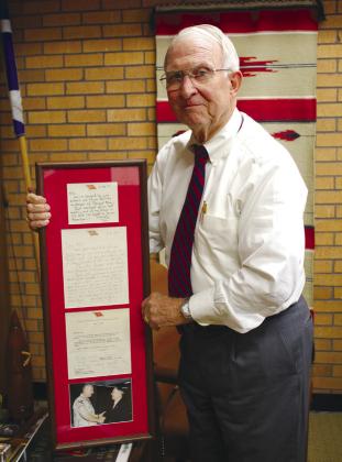 William Ford, of Shawnee, holds up a framed set of letters from and a picture of himself shaking hands with four-star General Tommy Franks, whom he trained in U.S. Army Artillery and Missile Officer Candidate School at Fort Sill in 1967. Countywide &amp;amp; Sun/Natasha Dunagan