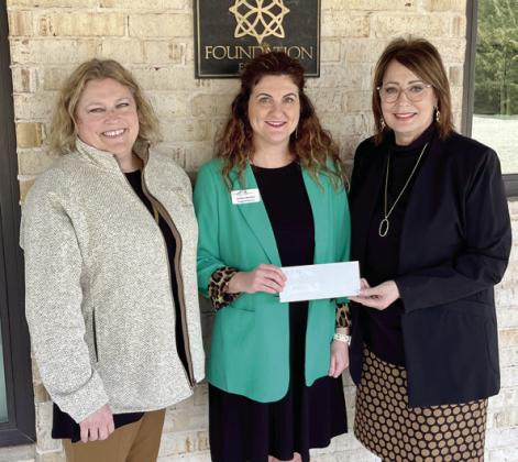 Kathy Laster, Ph.D. President &amp;amp; CEO Avedis Foundation (right) and Tracy Meeuwsen, Program Director Avedis Foundation (left) present a check for a $12,000 grant to Amber Shelton, Regional Director Junior Achievement of Oklahoma. Photo provided
