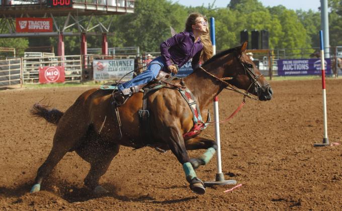 Kinzlee Jones of Shawnee makes the turn around the end pole on the morning of July 8.