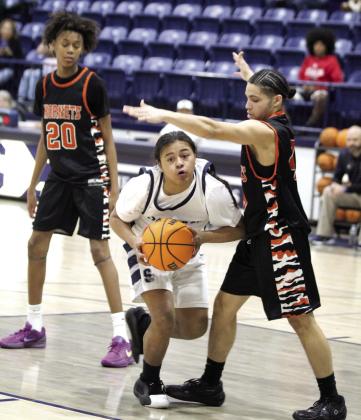 Shawnee freshman Glen Price drives to the hoop and makes the last basket of the night.