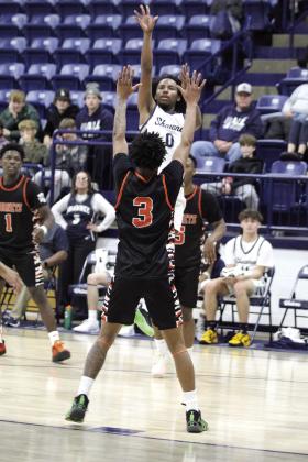 Shawnee senior Daytain Patton is fouled in his attempt at a jump shot.