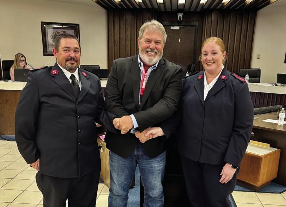 Salvation Army Captains, Thomas and Leanna Marion, pose with Mayor Eric Stephens after being introduced by Glenn Peck during public comments of the Aug. Shawnee City Commission meeting. The Marions are settling into their new position and hoping to build a positive relationship with the city government. Photo Provided