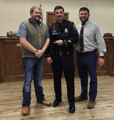 McLoud City Manager Cody Roe (left) and Mayor Daniel McClure (right), pose with Meritorious Service Award recipient, Major Alan Pinette. The award recognizes dedication, professionalism and commitment to service. Cheyanna Dietz, Countywide &amp; Sun, THS Intern