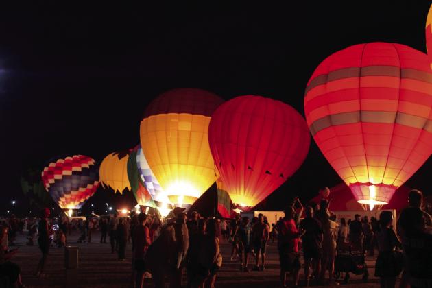 Hot-air balloons light up during the Balloon Glow on Friday, Aug. 9, at the FireLake Fireflight Balloon Festival. There were 25 balloons at the event this year, mostly from Oklahoma and the surrounding states. They also offered tethered rides and early morning balloon launches. Countywide &amp; Sun/Natasha Dunagan