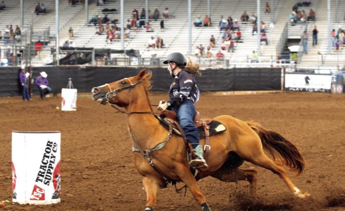 Corissa Evans of Malanda, Queensland, Australia, rounds the third barrel on the morning of July 17, the final day of competition at the IFYR. Evans is the daughter of Pamela Evans. She also competes in pole bending.
