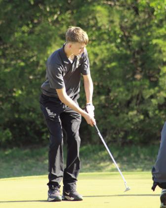 Tecumseh freshman Preston Haines putts to the second hole.