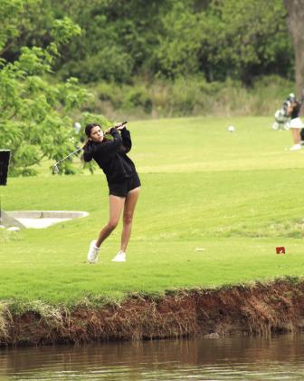 Tecumseh sophomore Kholi Shirey drives across a pond to the fifth hole.