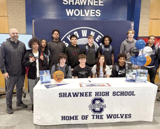 Shawnee student Carter Whipkey, seated second from left, is surrounded by members of the basketball team and Coach Eric Litherland, far left, after signing a letter of intent with Southwestern Christian University for basketball on April 30. Photo courtesy of Amanda Johnson