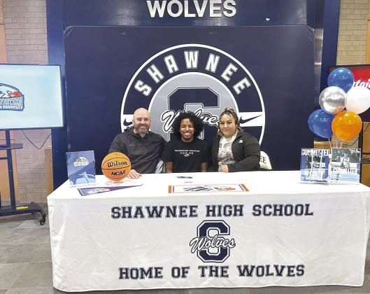 With Head Basketball Coach Eric Litherland and his mother, Shawnee student Daytain Patton signed a letter of intent with Southwestern Christian University for basketball on April 30. Photo courtesy of Amanda Johnson