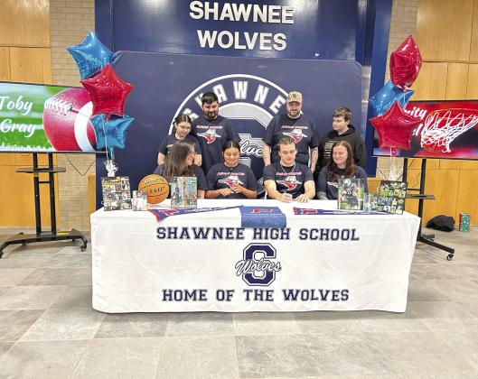 Surrounded by family, Shawnee sturdent Toby Gray signs a letter of intent with Panhandle State University in football on April 30. Photo courtesy of Amanda Johnson