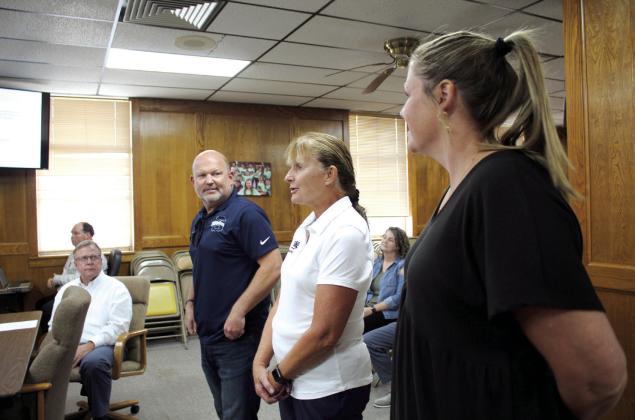 Shawnee Head Swim Coach Valarie Colburn speaks, as Athletic Director Dax Leone, left, and Assistant Athletic Director Julia Holland listen at the Oct. 2 Board of Education meeting. Colburn was named the 2022-23 OSSAA Swim Coach of the Year. Countywide &amp;amp; Sun/Natasha Dunagan