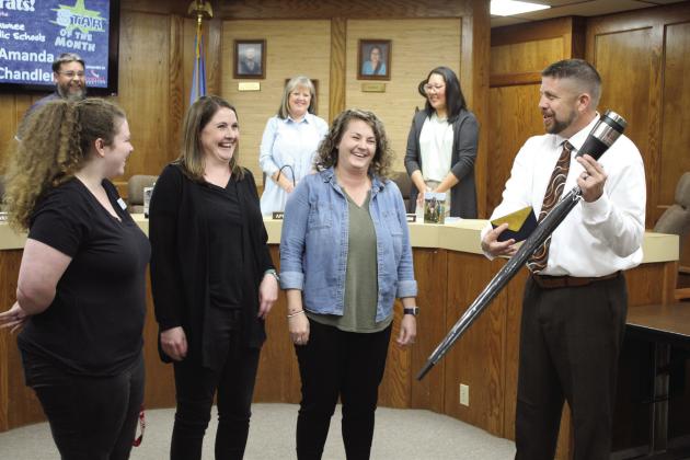 Shawnee Superintendent Dr. Aaron Espolt presents Amanda Chandler, one of three counselors at Shawnee Middle School, with an umbrella, insulated cup and gift card, as the Star of the Month, during the Oct. 2 Shawnee Board of Education meeting. Also shown, foreground from left, are SMS Assistant Principal Hannah Holland and Principal Keely Tolin. Countywide &amp;amp; Sun/ Natasha Dunagan