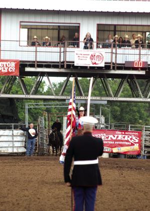 U.S. Marine Veteran, Sgt. Jonathan Wright, stands at attention in Arena #2, as his mother, Maria Wright, sings the national anthem to kick off the championship round of the IFYR on July 17. Miss Teen Rodeo Violet Camerino of CA rode out with the American flag. While on active duty in South Carolina, Wright had videos shared to him of his mother singing the anthem for the last 14 years, but he finally got to see her performance in person. Natasha Dunagan, Countywide &amp;amp; Sun