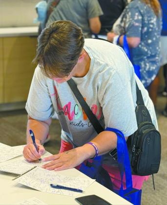 Pleasant Grove PS teacher Kathy Ferguson signs a thank-you cards to sponsors. Photo Provided