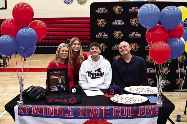 Pictured left, North Rock Creek’s Caleb Looper signed his letter of intent to attend Seminole State to play baseball next year. Watching him are his parents, Aaron and Magan and his sister Abigail. Photo courtesy of Gowin Photography