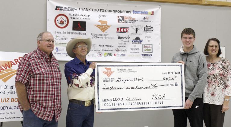 Greyson Wood of Dale poses with a display check for $2,700 after winning first place in the Second Annual Pottawatomie County Cattlemen's Association Beef Quiz Bowl on Nov. 4. Also shown are Wood's grandfather, Steven Rasure, far left, PCCA President Bob Freeman, and grandmother, Deborah Rasure, far right. Wood received a $200 bonus since his grandparents are members of the PCCA. Second place went to Stephen Wickard of North Rock Creek, and third place went to Austin Ramsey of Tecumseh.
