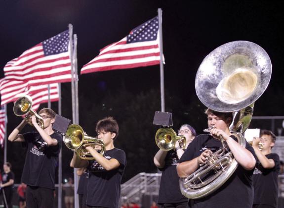 With U.S. flags flying in the background, the Tecumseh Savage Pride Marching Band performs at halftime of the homecoming game on Sept. 20. The show theme for the band this year is “America the Beautiful,” and included in the performance was recognition of veterans in the audience and standing for the playing of “Taps.” Countywide &amp; Sun/Natasha Dunagan