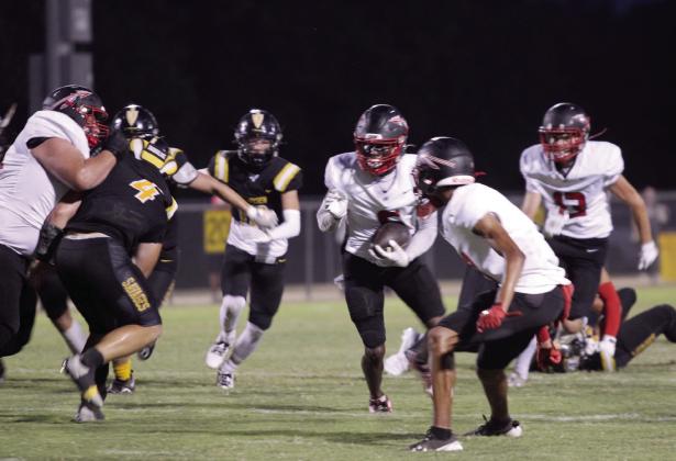 McLoud senior Shaun Hill dodges Savages as he carries the ball for a third down during the homecoming game at Tecumseh on Sept. 20.  Countywide &amp; Sun/Natasha Dunagan