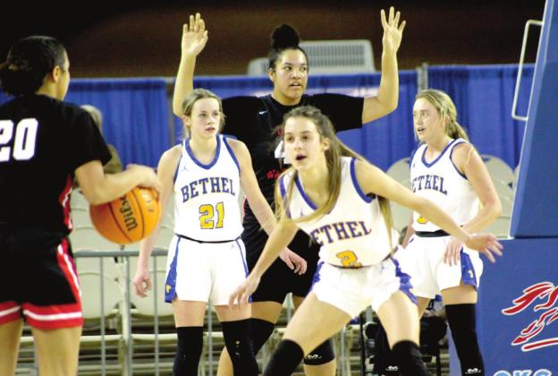 Bethel Lady Wildcats Josie Megehee, Baylee Tapley, and Brooklyn Duff play defense against Idabel (including one 6’ 4” player) during the Class 3A State Tournament quarterfinal game on March 9 at the Fairgrounds Arena. Idabel player #20 was dribbling to run out their time in the fourth quarter, as the Bethel fans booed.