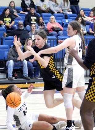 Tecumseh’s Kenzli Warden has the ball knocked out of her hands by one Perkins-Tryon defender and nearly trips on another on her way to the basket during the First United Bank Classic consolation championship round in Bethel on Dec. 11. The Lady Savages won that game, 39-35. They lost to Byng in the first round on Dec. 9, 37-54, and won against Bridge Creek, Dec. 10, 74-32. Countywide &amp;amp; Sun/Natasha Dunagan